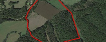 Aerial view of land with a property border demarcated